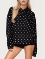 Close-up of black hoodie with white polka dots featuring front pocket and ribbed cuffs - S / Black