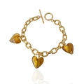 Detailed macro view of amber heart pendants with gold foil on an elegant OT buckle bracelet - Bracelet / Coffee
