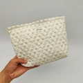 Detailed close-up of quilted floral cosmetic bag with pink flowers and blue dots pattern - White Floral