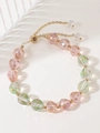 Bowknot beaded bracelet with pink crystals and golden metal accents on a white tray - Pink Iridescent Faceted Crystal Bracelet (11198)