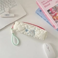 Detail of quilted pencil case with blue rabbit embroidery and mint green handle strap - Running Rabbit