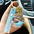 Blue acrylic quicksand heart keychain with bell and Pretty Good strap - Light Blue