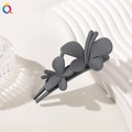 Close-up of a matte dark grey butterfly hair clip on white textured background - Double Butterfly Clip - Matte Blue Gray