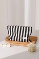 Close-up of striped canvas makeup bag with lipstick and candle on a wooden tray - Black Stripe