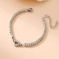 Close-up of silver bead bracelet with heart charm and adjustable lobster clasp closure - Heart and Knot / Steel