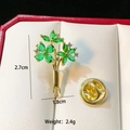 Elegant gold flower brooch with green gemstones and crystals in a jewelry box - Gold Bouquet C200