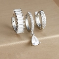 Macro detail of three silver earrings featuring teardrop and baguette-cut cubic zirconia - Three-Piece Set / Silver-White Zirconia