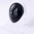 Macro side view of a black silicone nose model on a clear acrylic display stand - Black-Nose