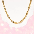 Detailed view of golden paperclip chain necklace on white paper with bokeh background - Paperclip Chain