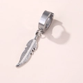 Macro view of stainless steel hoop earring with a detailed silver feather pendant - Feather