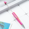 DIY beadable ballpoint pen in gradient rose pink metallic finish on desk background - Candy Rose Red Gradient
