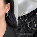 Detail showing 3cm diameter of oversized golden hoop earrings on model with measurements - 3cm / Minimalist Hoop / Gold