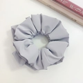 Detail of a large matte lilac faux leather scrunchie with elegant pleated texture - Grey (Three-layer)