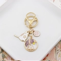 Detailed view of golden enamel charms featuring sakura cat and wisteria moon scene - Cat & Wisteria Moon Shadow