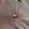 Macro view of silver titanium steel snake chain with a polished round bead pendant - Silver
