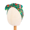 Christmas bow baby turban hat in green festive print on a neutral display stand - Festive Green Gingerbread Print Style (20952)