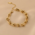 Minimalist 18K gold knotted chain necklace with lobster clasp on champagne silk background - Bracelet / Gold