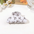 Detailed view of white butterfly hair claw clip with floral patterns on a desk - 8cm Square Head / Light Pink Butterfly