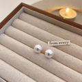 Macro shot of minimalist round white pearl stud earrings inside a wooden jewelry box - Small (1.2cm) / White