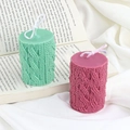 Mint green and berry red Christmas pillar candles with cozy knit texture on vintage book - Knitted Column 185g