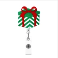 Christmas gift box badge reel with green stripes, red bow, and acrylic glitter finish - Gift Box