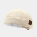 Detailed macro view of beige canvas brimless docker cap with W leather patch and metal buckle - Adjustable / Letter W Patch Beige