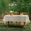 Detailed texture of beige linen tablecloth with vertical stripes on an outdoor dining table - Linen Yarn Hem