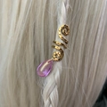 Close-up of golden spiral hair jewelry with pink teardrop crystal on braided blonde hair - Pink Pendant