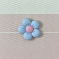 Macro detail of a light blue matte flower resin charm with a pink center on a striped surface - 06# Blue 2*2cm