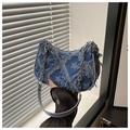 Detailed view of frayed denim fabric with gradient star pattern and metal chain strap - Blue Star