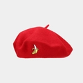 Detail of red wool beret featuring small banana embroidery and classic stem top - One Size / Red