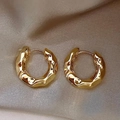 Macro shot of gold S925 silver hoop earrings with unique irregular lava texture - Lava Texture Hoop / Gold