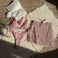 Detailed flat lay of pink glitter mesh three-piece bikini set with wrap skirt and props - Pink