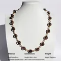 Handmade glass beaded necklace with dark glitter beads and gold plated accents on a neck model - Handmade Lampwork Mid-length Necklace / Dark Brown Lampwork
