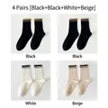 Set of 4 pairs of cotton crew socks featuring striped ribbed cuffs in black, white, and beige - One Size (EU 35-40) / 4 Pairs (2 Black/1 White/1 Beige)