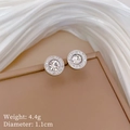 Detail of crystal halo stud earrings on beige box showing 1.1cm diameter and 4.4g weight - Silver Stud Earrings (Q112 Silver)