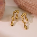 Detailed close-up of golden irregular lava-style flowing wave earrings on natural stones - Gold