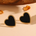 Detail of heart-shaped black shell earrings with gold beaded edges on a natural background - Gold Black Shell Stud Earrings