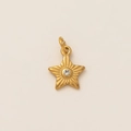 18K gold plated star pendant necklace with sparkling center diamond on beige background - Star