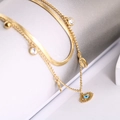 Gold double-layered necklace featuring flat snake chain and evil eye sunburst pendant - Necklace / Gold