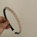 Elegant beige braided headband with a soft woven texture and comfortable black padded ends - Beige
