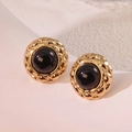 Detailed macro view of vintage gold-plated round stud earrings with black resin inlay - Black