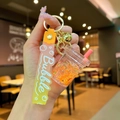 Detailed shot of bubble tea keychain with orange beads, bell, and silicone wrist strap - Orange Luminous Bubble Bead Milk Tea Cup
