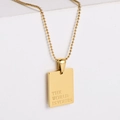 Gold beaded chain necklace with rectangle pendant engraved with THE WORLD IS YOURS - THE WORLD IS YOURS
