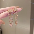 Detalle macro de pendientes de borla rosa con base de flor dorada y circonitas finas - Borla de espiga de trigo con circón rosa (Pin de plata 21#)