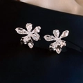 Elegant silver orchid flower earrings with textured hammered finish on a dark background - Hammered Orchid Silver Needle Style / Silver