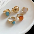 Close-up of geometric gold rings with colorful gemstones on a white ceramic tray - Gold (5-Piece Set)