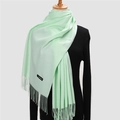 Pale green cashmere-texture scarf with long tassels displayed on a black mannequin - 200*70cm / Fruit Green