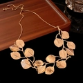 Elegant gold leaf necklace with adjustable slider chain on a dark wooden tray display - 45# Necklace - Gold - Textured Leaf Adjustable