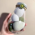Detail of colorful makeup sponges in a clear jar decorated with a daisy and twine - Avocado Green 6 Pcs